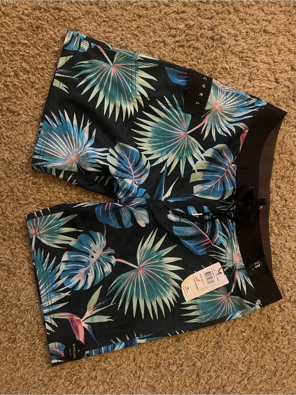 Rip Curl Black Swim Shorts with Blue-Green Tropical Leaves